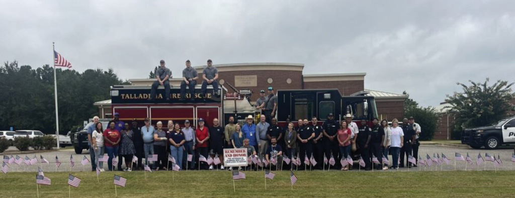 Photo of people standing in front of a fire truck